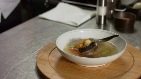 The chef serves fish soup. Close up Stock Footage 131152045