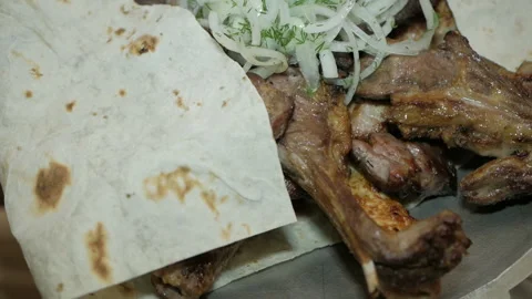 The chef serves a freshly prepared meat dish. Serving meat dishes Video stock 99296455