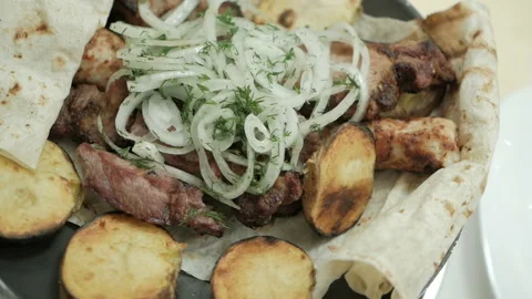 The chef serves a freshly prepared meat dish. Serving meat dishes Stock Footage 99298852