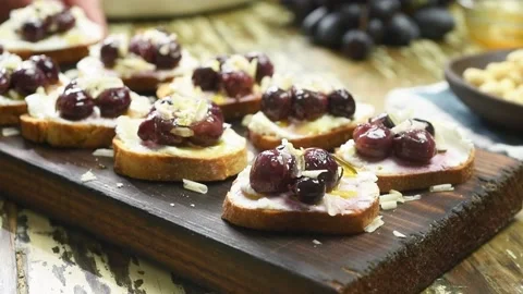 The chef serves the freshly prepared roasted grapes crostini. Stock Footage 202176828