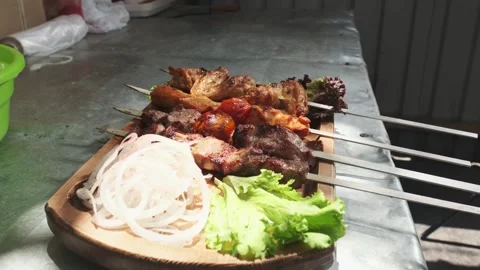 The chef serves kebabs with chicken, cape and liver on a wooden board with Stock Footage 270747646