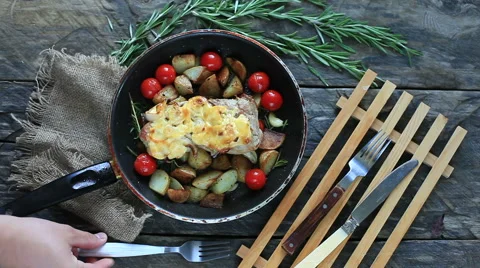 The chef serves the meat with herbs and tomatoes Stock Footage 51411795