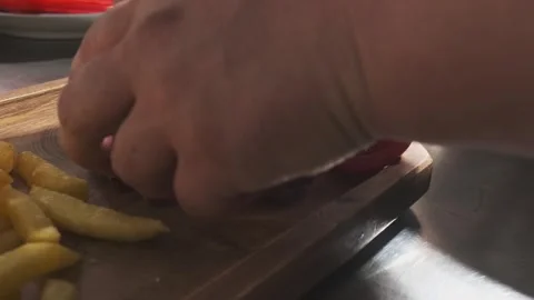 The chef serves meat, potatoes, herbs, tomatoes and vegetables on the board Stock Footage 263102087