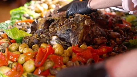 Chef Serves Roasted Lamb and Vegetables 库存照片