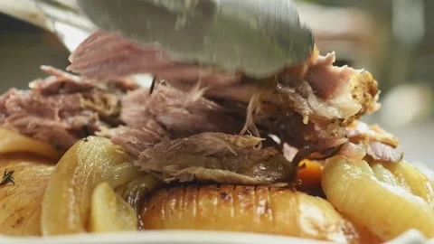 Chef serves roasted lamb shoulder with vegetables. Stock Footage 195531251
