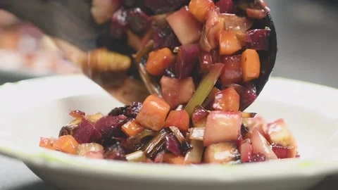 Chef serves roasted root vegetables salad. Stock Footage 159908473