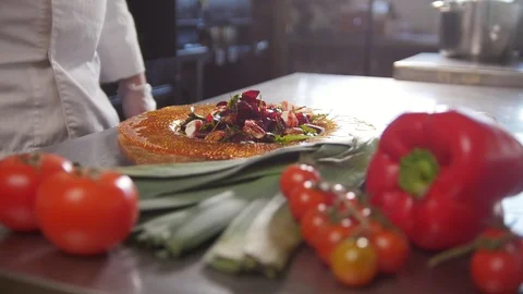 Chef serves the salad by placing the components on a plate and adding the sauce Stock Footage 86069483