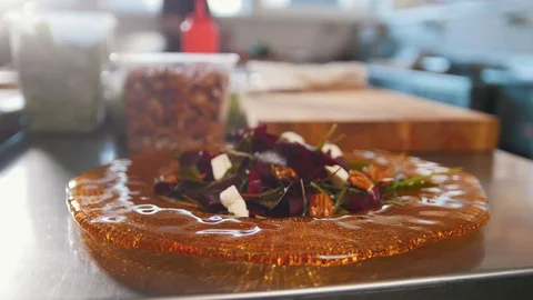 Chef serves the salad by placing the components on a plate and adding the sauce Stock Footage 86164879