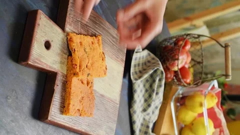 The chef serves slices of tomato bread on a wooden cutting board. Stock Footage 333708381