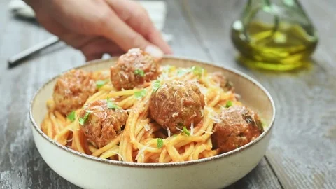 The chef serves spaghetti with meatballs on the table. Stock Footage 202072674