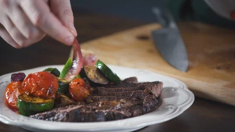 Chef serves vegetables a grilled steak dish in a restaurant. Stock-Footage 124712911