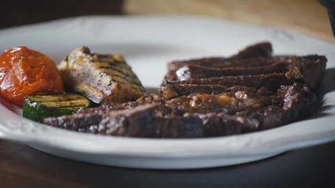 Chef serves vegetables a grilled steak dish in a restaurant. Stock-Footage 124713061
