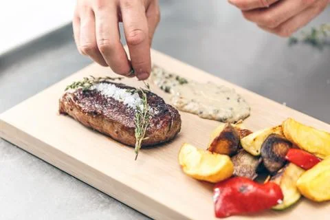 Chef serving beef steak Stock Photos