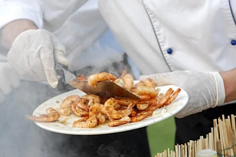 Chef serving deep fried prawns Stock Photos