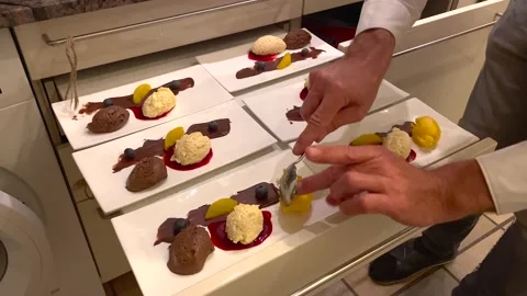 Chef serving delicious dessert with chocolate and vanilla mousse in restaurant. Video stock 145828558