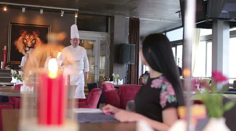 Chef serving delicious meal in his restaurant to female customer 動画素材 67456337