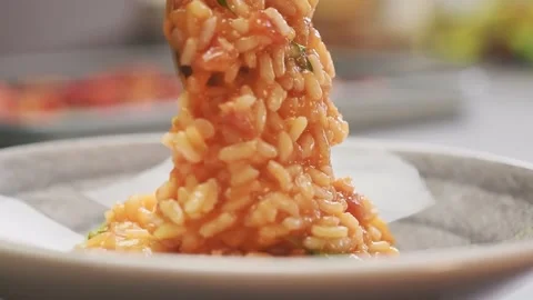 Chef serving delicious tomato risotto, on a plate. Stock Footage 159399597