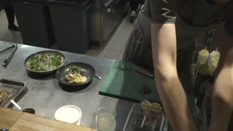 Chef serving a dish in the restaurant kitchen Stock Footage 247030262