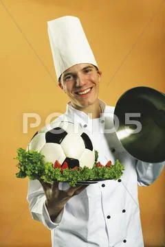Chef serving football in plate Stock Photos