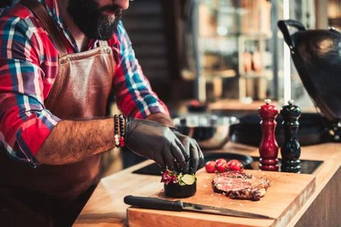 Chef serving freshly cooked meat in a restaurant Stock Photos