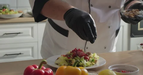 Chef serving healthy vegetable salad plate with walnut. Dish serving. Cooking Stock Footage 277955581
