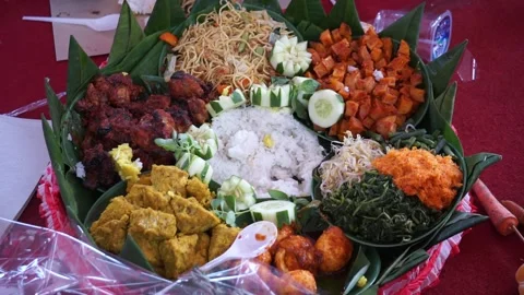 Chef serving nasi tumpeng (cone rice) served with urap-urap (Indonesian salad) Stock Footage 246148237