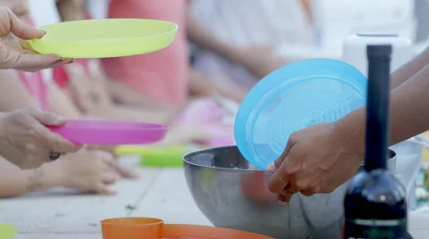 Chef serving a natural nutricious herb salad to children at park Stock Footage 54466006