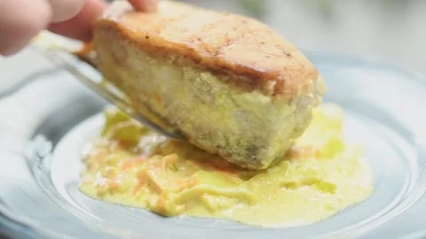 Chef serving piece white fish on a creamy leek sauce. Stock Footage 162060369
