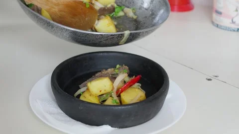 Chef serving potatoes, meat and vegetables on plate Stock Footage 288497574