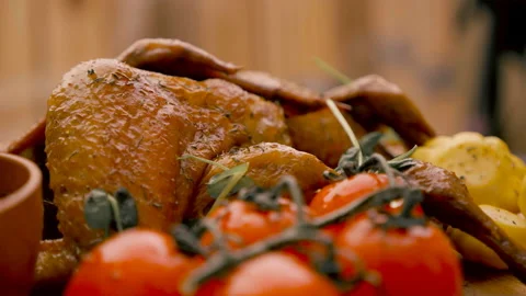 Chef Serving Roasted Chicken on Plate with Herbs Stock Footage 143113127