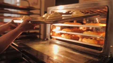 The chef sets the oven pastries. Baking process. Work in the kitchen. Stock Footage 108960305