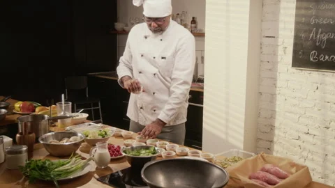 Chef Setting Up Large Kitchen Table with Ingredients for Cooking Master Class Stock Footage 332568973