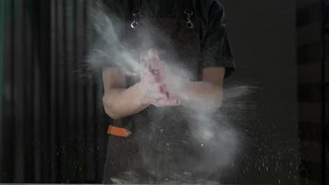 Chef shakes flour off his hands Stock Footage 134955146