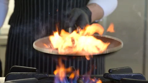 Chef shakes the pan Stock Footage 260453928