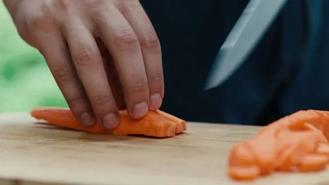 The chef shallows carrots quickly with a knife hands close up Stock Footage 130992273