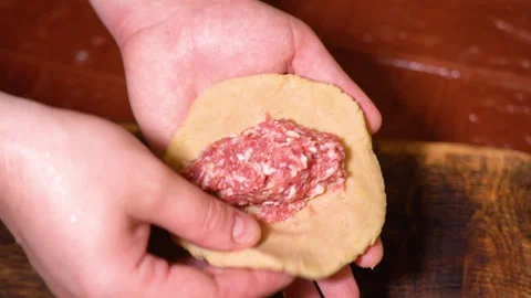 A chef is shaping the dough with meat inside to make dumplings. Stock Footage 252603456