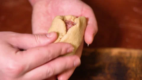 A chef is shaping the dough with meat inside to make dumplings. Stock Footage 252604039