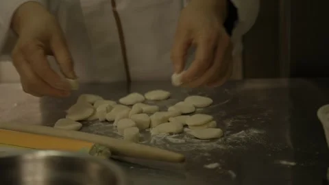 Chef Shaping Dough Pieces by Hand in Beijing Street Food Kitchen, Close Up Stock Footage 345880377
