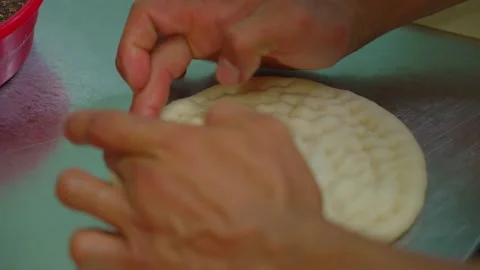 Chef shaping raw Uzbek flatbread, lyepeshka, before baking, close-up Stock Footage 332150172