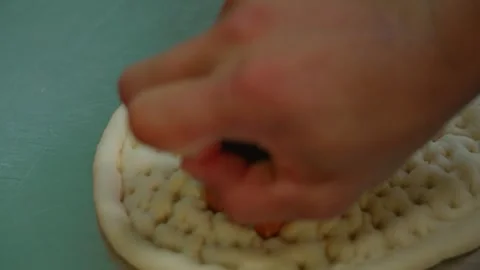 Chef shaping raw Uzbek flatbread, lyepeshka, before baking, close-up Stock Footage 346605641