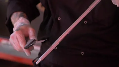 Chef is sharpening a cooking knife Stock Footage 143378715