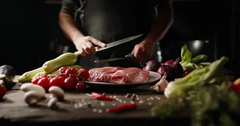 Chef sharpening his knife in front of kitchen table. Cooker preparing his tools Video stock 144281315