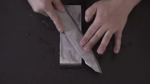 Chef Sharpening His Knife with a Pink Stone. 50 fps. Stock Footage 141027654