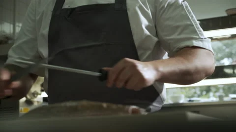 Chef is sharpening the knife before cutting fish Video stock 163317191