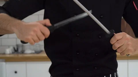 Chef is sharpening knife in the kitchen, ib01 Stock Footage 109122978