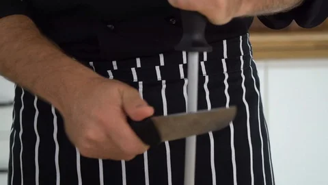 Chef is sharpening knife in the kitchen, ib01 Stock Footage 109122990