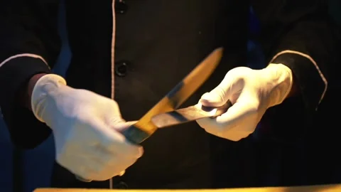 Chef sharpening knife in restaurant slow motion Stock Footage 230080479