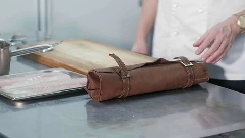 Chef sharpens a knife in the kitchen of the restaurant Видео 82962733