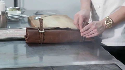 Chef sharpens a knife in the kitchen of the restaurant Видео 83001302