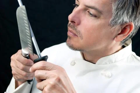 Chef sharpens knife Stock Photos